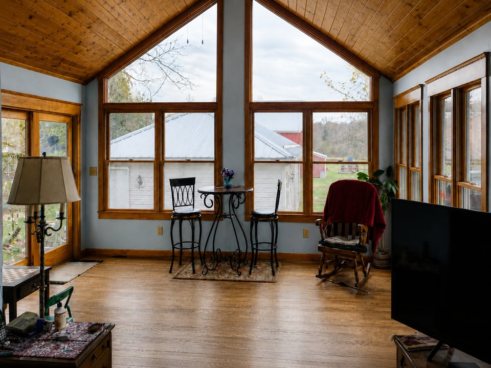custom home sunroom addition with vaulted ceiling by Swank Builders Inc in Fenton MI