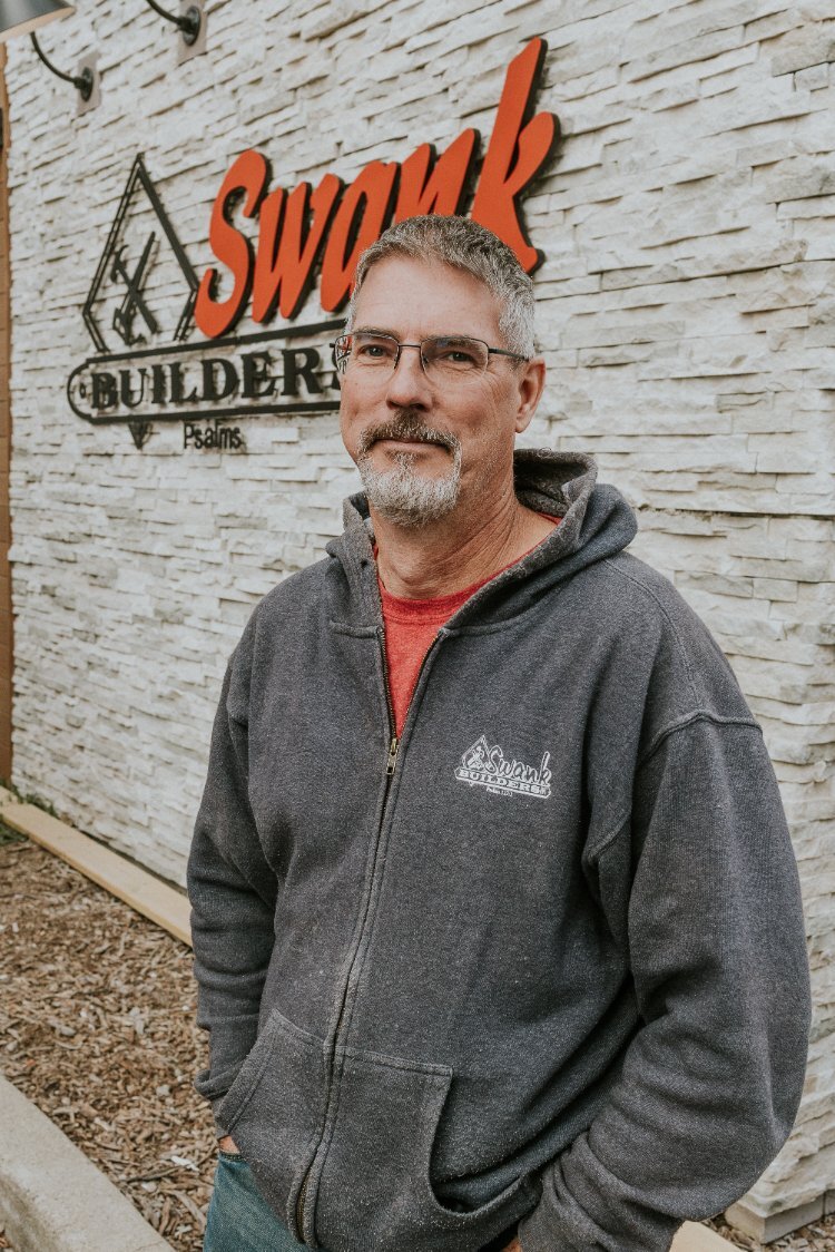 Keith Husted of Swank Builders Inc standing outside the custom home builder headquarters in Flint, MI.-optimized