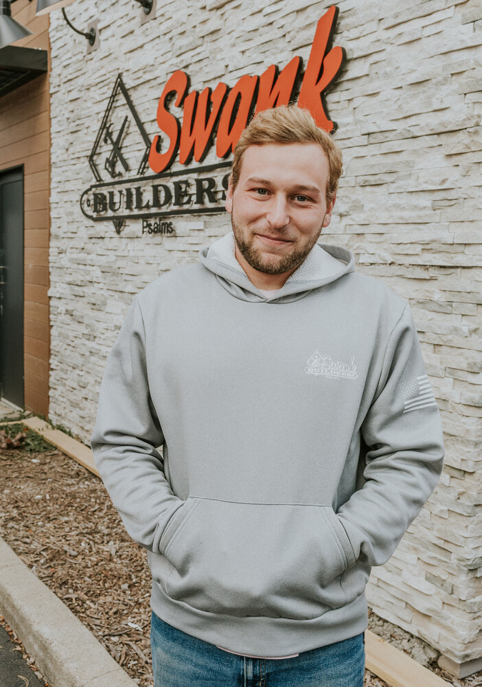 Adam Roehrer of Swank Builders Inc custom home builder team member portrait outside office in Genesee County MI