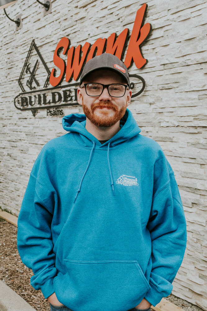 Andrew Barker of Swank Builders Inc custom home builder team member portrait outside office in Genesee County MI