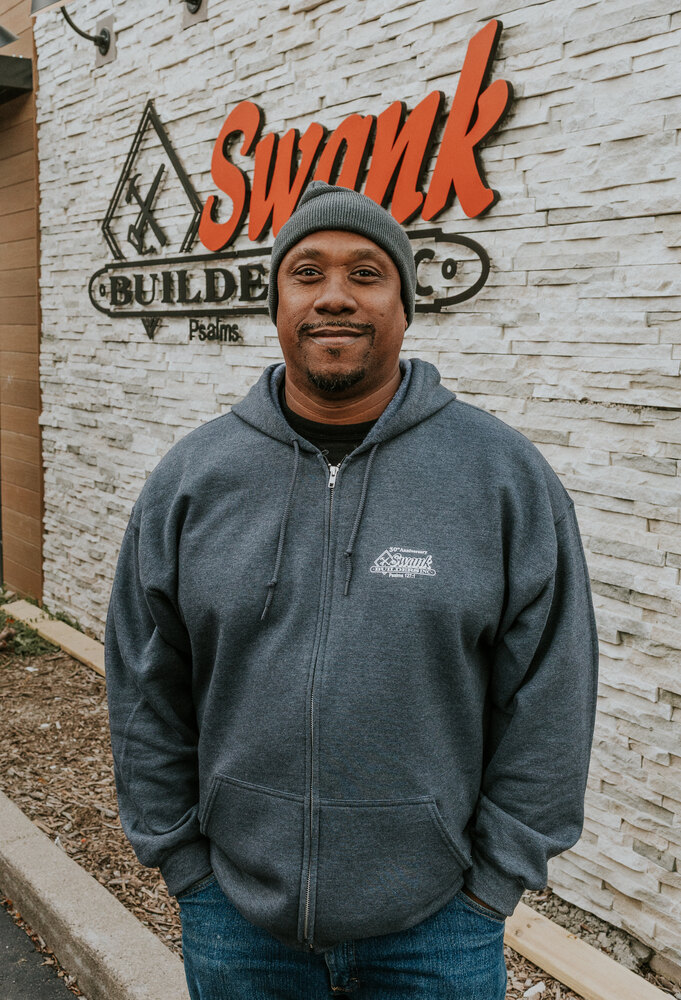 Anthony Perdue of Swank Builders Inc custom home builder team member portrait outside office in Genesee County MI