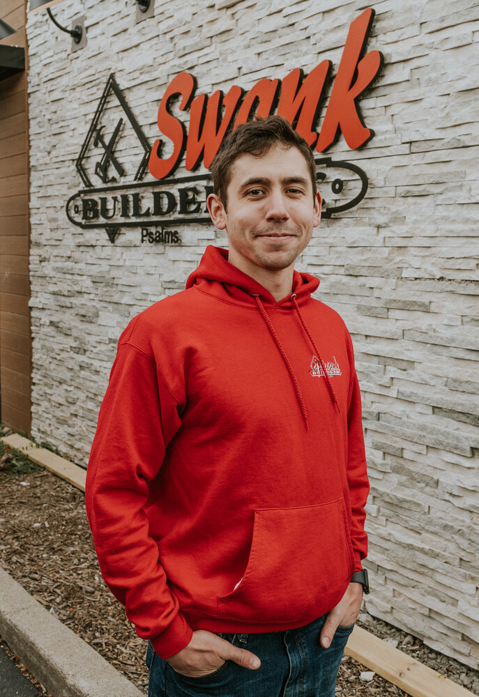 Dominick Thomas of Swank Builders Inc custom home builder team member portrait outside office in Genesee County MI