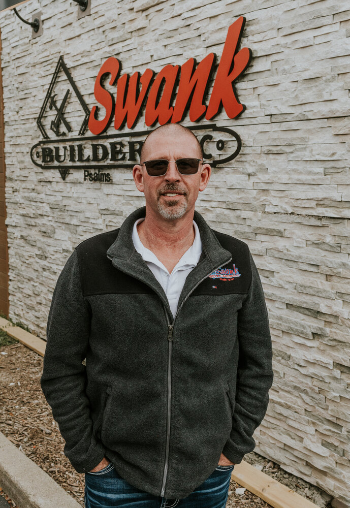 Frank Griffin of Swank Builders Inc custom home builder team member portrait outside office in Genesee County MI