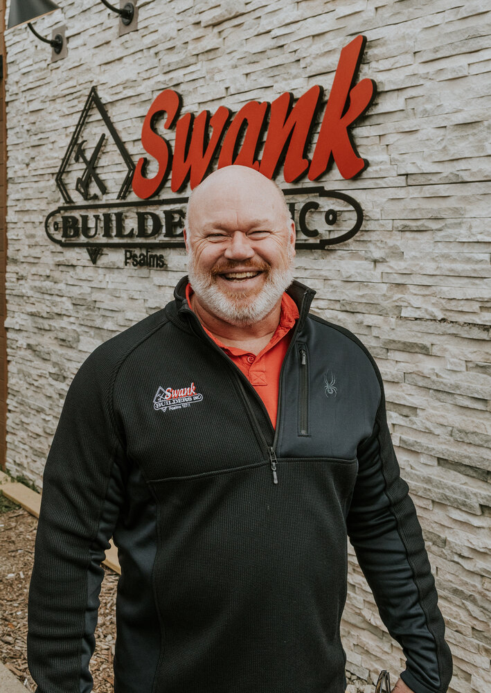 Kyle Stottmeister of Swank Builders Inc custom home builder team member portrait outside office in Genesee County MI