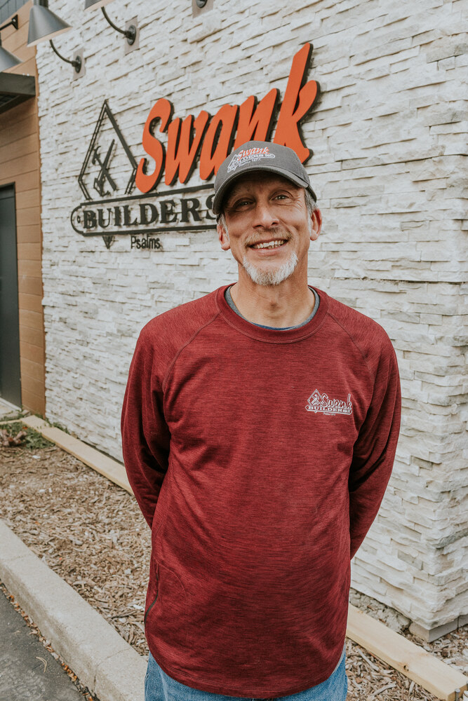 Mike Montney of Swank Builders Inc custom home builder team member portrait outside office in Genesee County MI