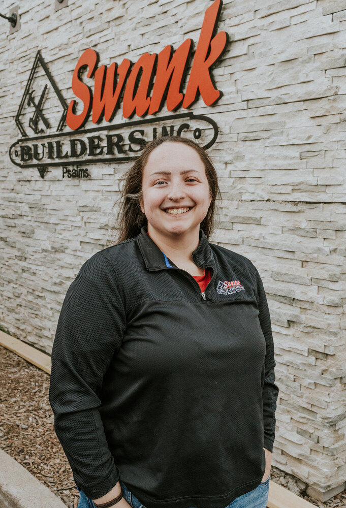 Rachel Rock of Swank Builders Inc custom home builder team member portrait outside office in Genesee County MI