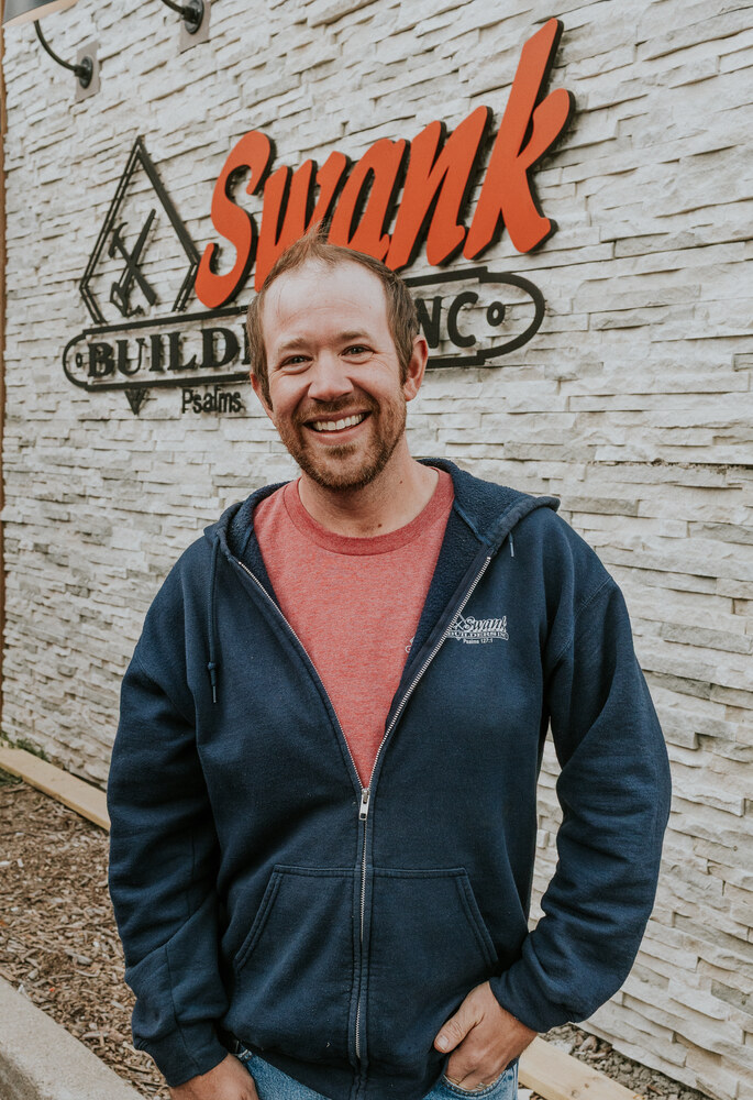 Will Lench of Swank Builders Inc custom home builder team member portrait outside office in Genesee County MI