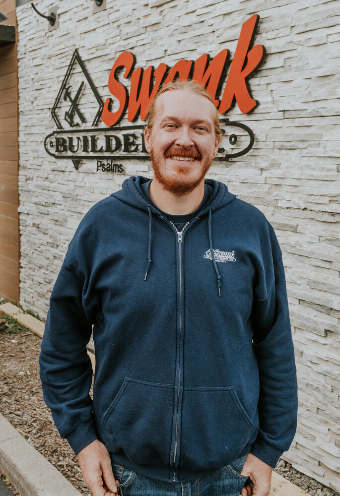 Zach Rich of Swank Builders Inc custom home builder team member portrait outside office in Genesee County MI