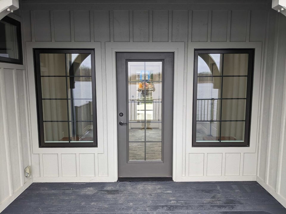 breezeway addition exterior by Swank Builders Inc featuring covered porch and waterfront deck in Fenton MI