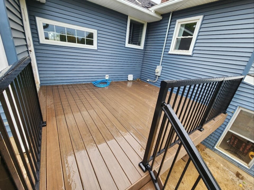 Swank Builders Inc composite deck with black aluminum railing in Michigan