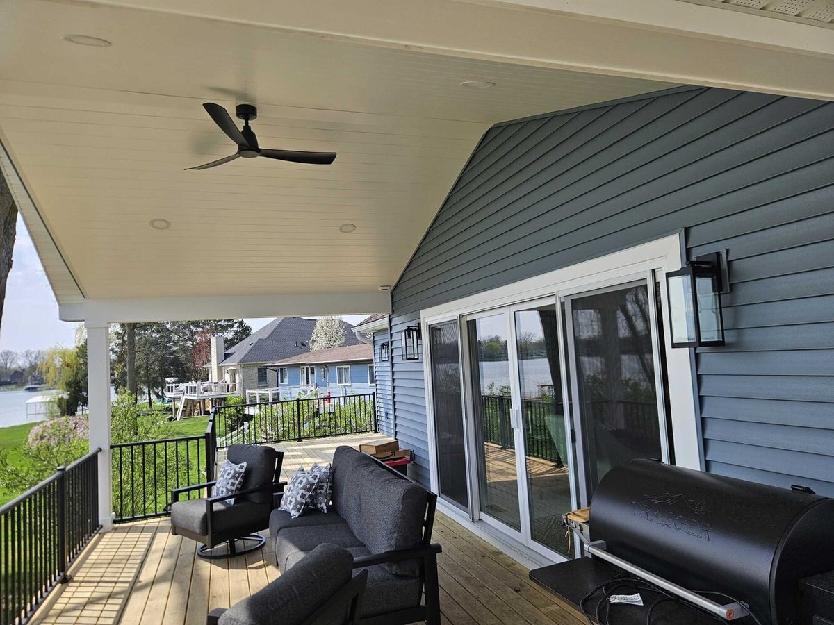 Swank Builders Inc covered deck with seating area and outdoor entertaining space in Michigan