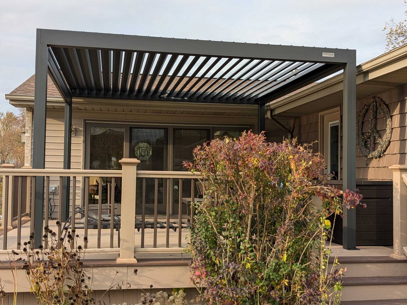 Swank Builders Inc custom deck with modern pergola for sun and rain protection in Michigan
