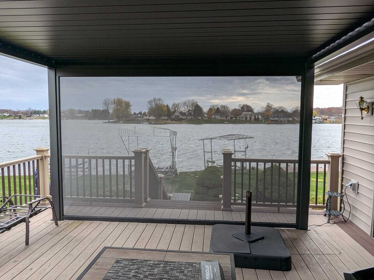 Swank Builders Inc screened pergola deck with lakefront view in Michigan