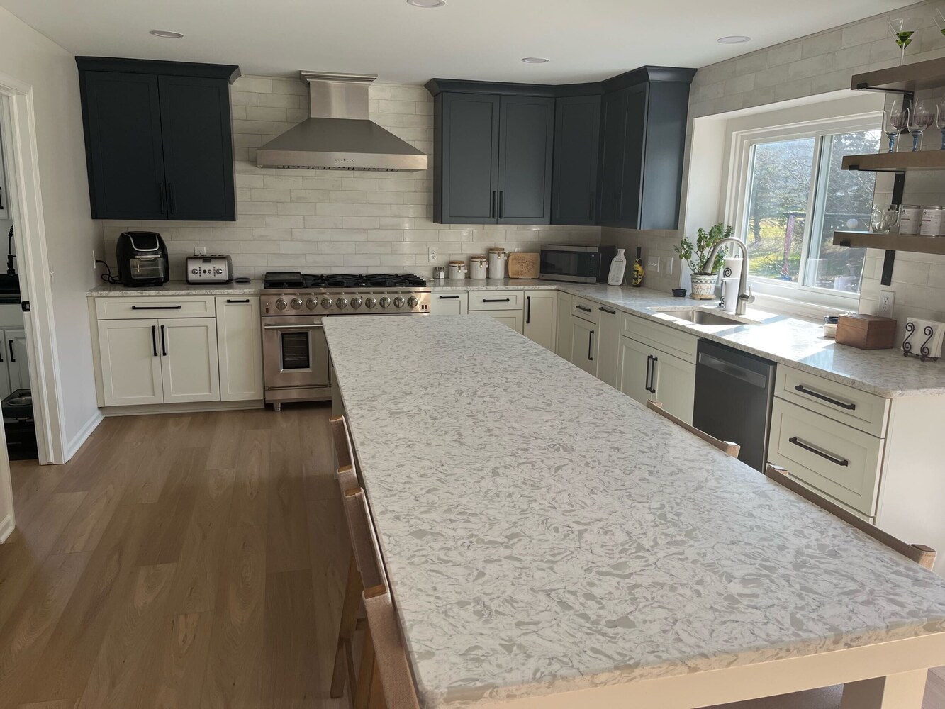 kitchen renovation with two tone cabinets and quartz countertops by Swank Builders Inc in Grand Blanc, MI