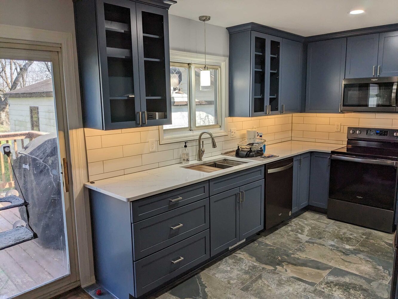 kitchen remodel with blue cabinets and white countertops by Swank Builders Inc in Flint, MI