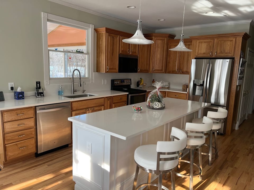 kitchen renovation with solid surface tops and custom cabinets by Swank Builders Inc in Swartz Creek, MI