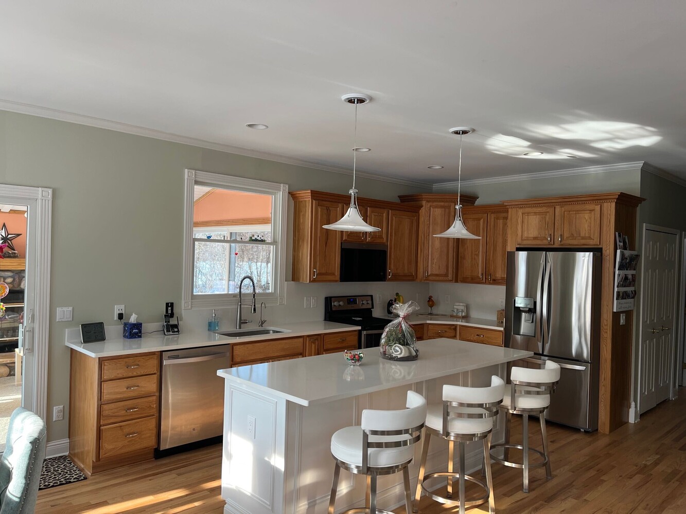 modern kitchen island design with ample workspace by Swank Builders Inc in Swartz Creek, MI