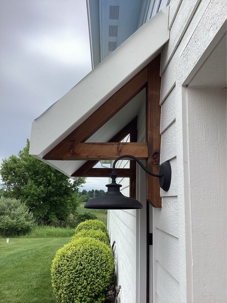 detailed view of custom brackets for steel roof awning by Swank Builders Inc in Goodrich, MI