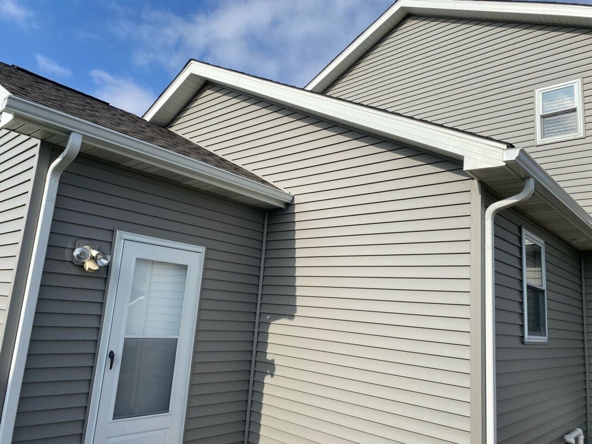 exterior renovation featuring grey siding and outdoor living space by Swank Builders Inc in Davison, MI