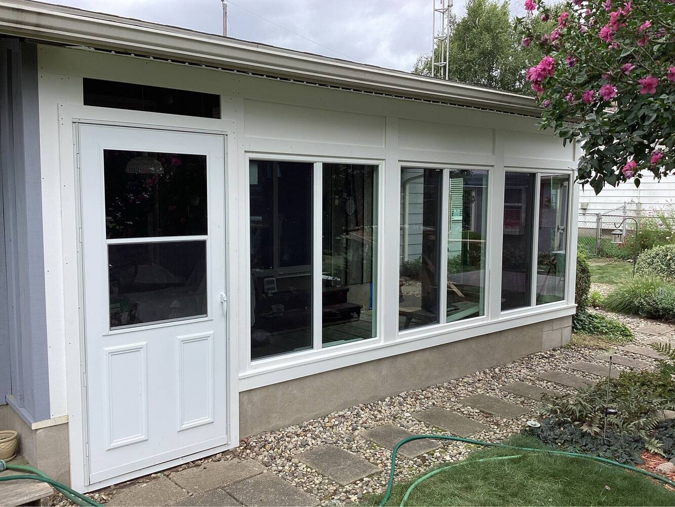Swank Builders Inc completed window installation and exterior door replacement on enclosed porch in Flint, MI.