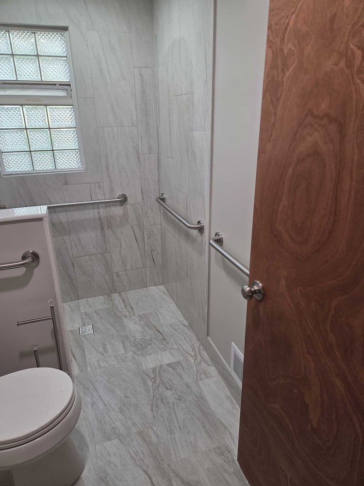 Swank Builders Inc bathroom remodel barrier free shower with tile walls and grab bars in Burton MI