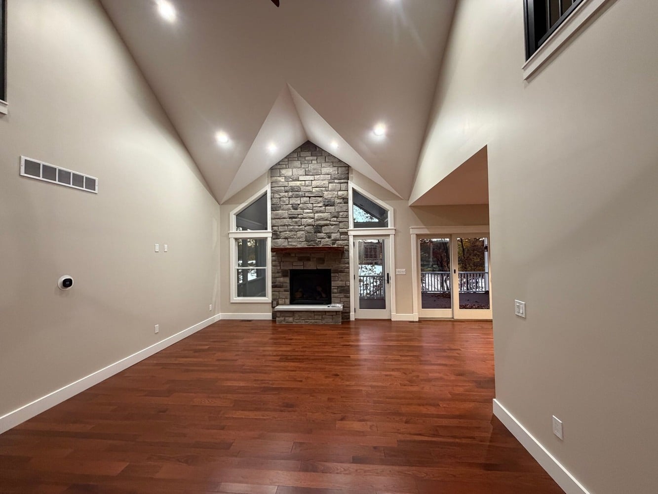 Swank Builders Inc custom home with open concept living room and fireplace focal point in Michigan
