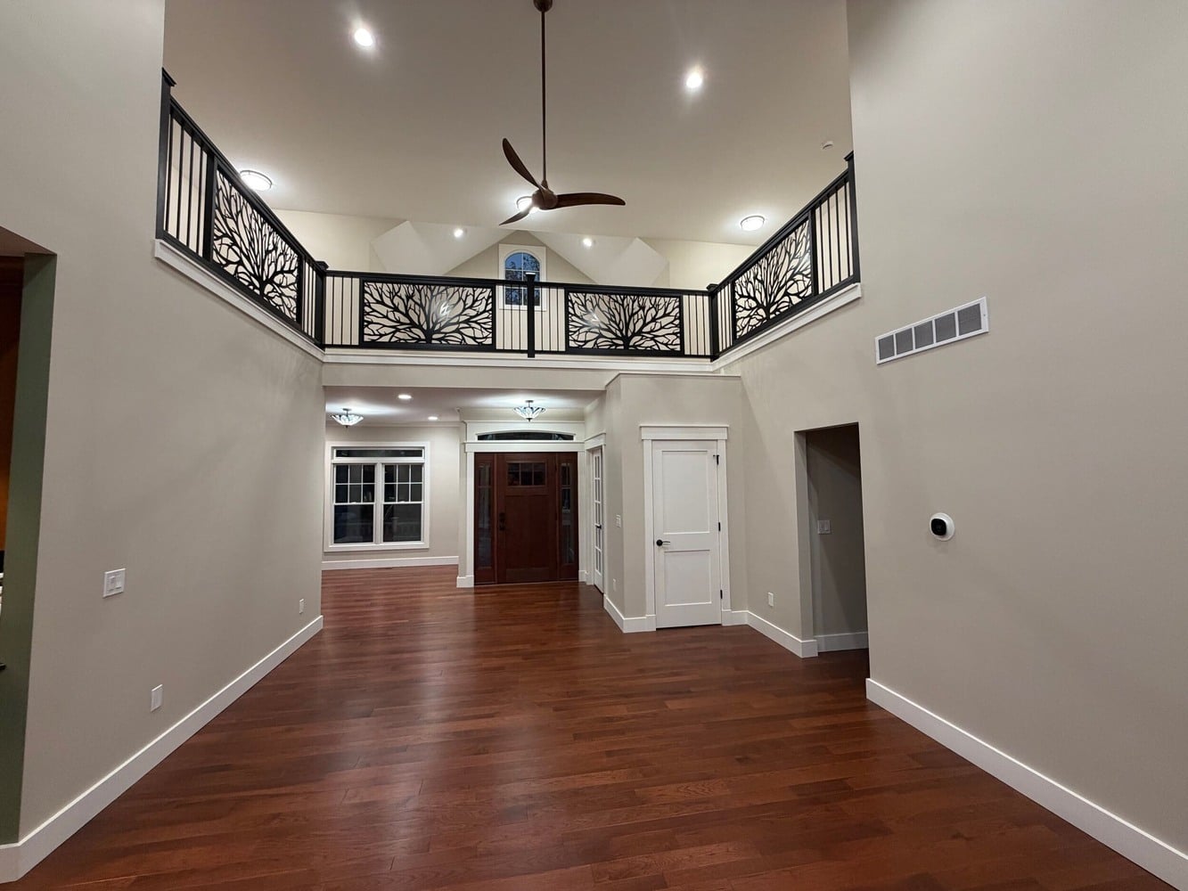 Swank Builders Inc custom home with open concept living room and second floor balcony railing in Michigan