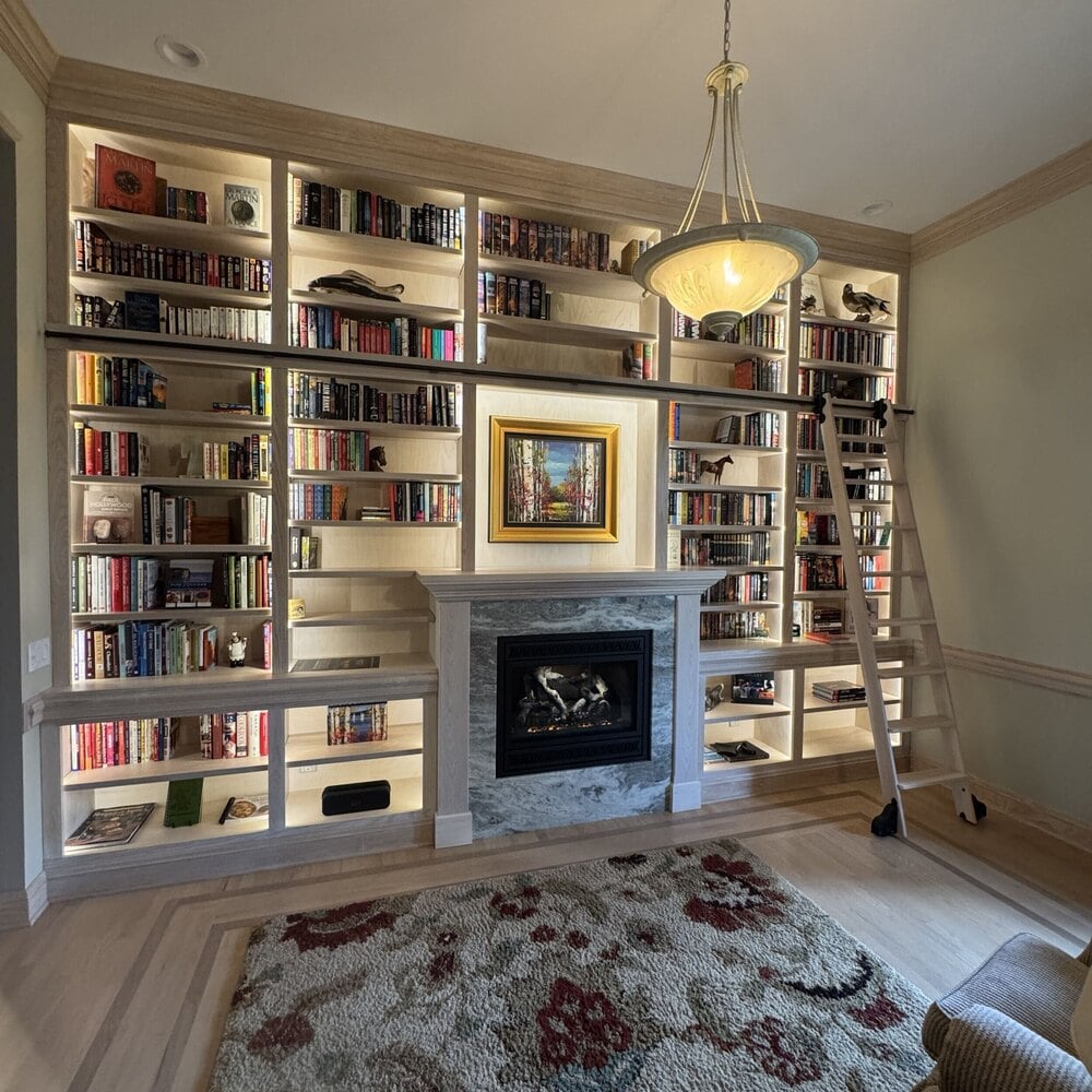 custom living room built ins with fireplace surround and integrated lighting by Swank Builders Inc in Genesee County MI