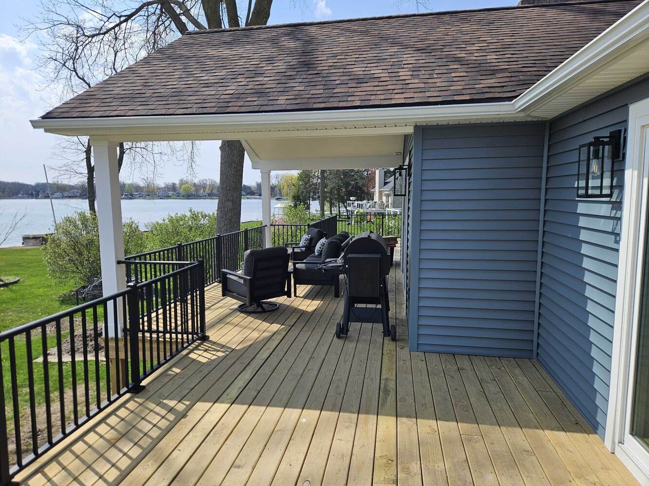 Swank Builders Inc covered deck with lake view and outdoor living space in Michigan
