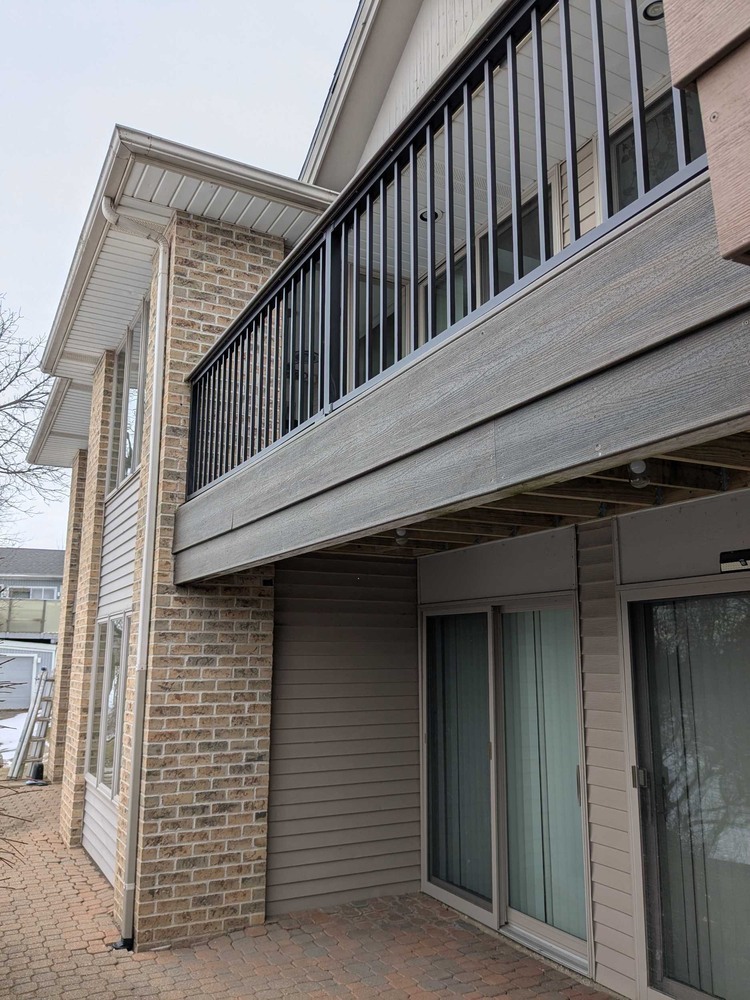 Swank Builders Inc elevated composite deck with aluminum railing and brick exterior in Michigan
