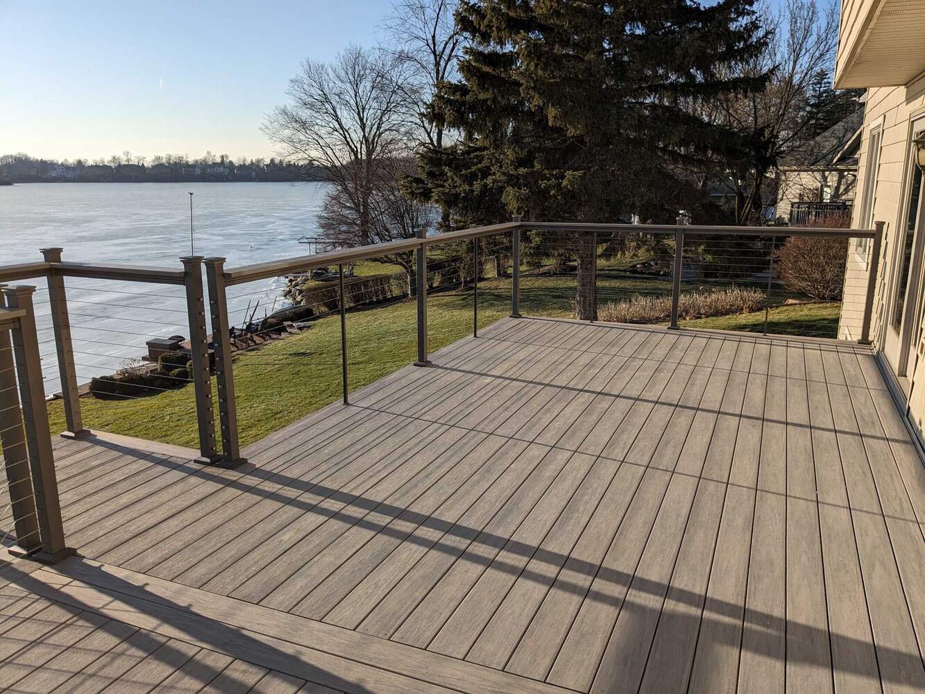 Swank Builders Inc waterfront deck with modern railing and scenic views in Michigan