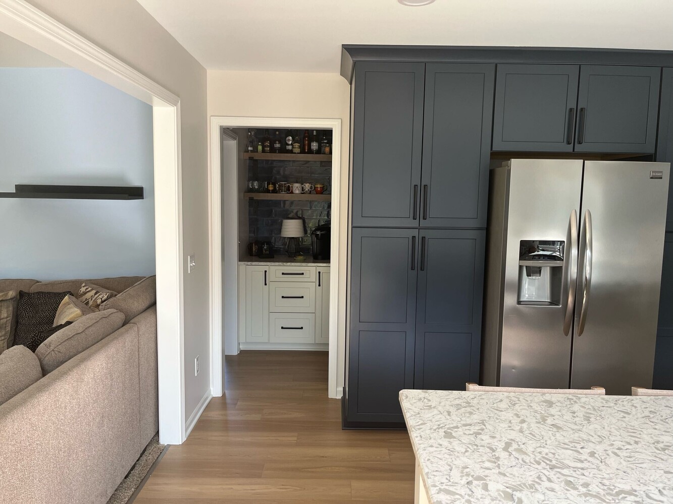 kitchen remodel with dark cabinetry and stainless steel refrigerator by Swank Builders Inc in Grand Blanc, MI