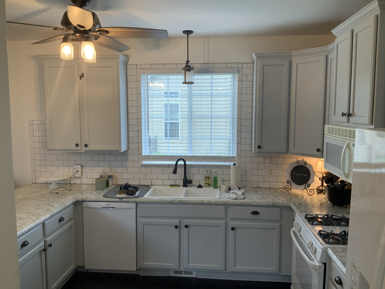 kitchen sink area with dated finishes before remodel by Swank Builders Inc in Grand Blanc, MI - Before
