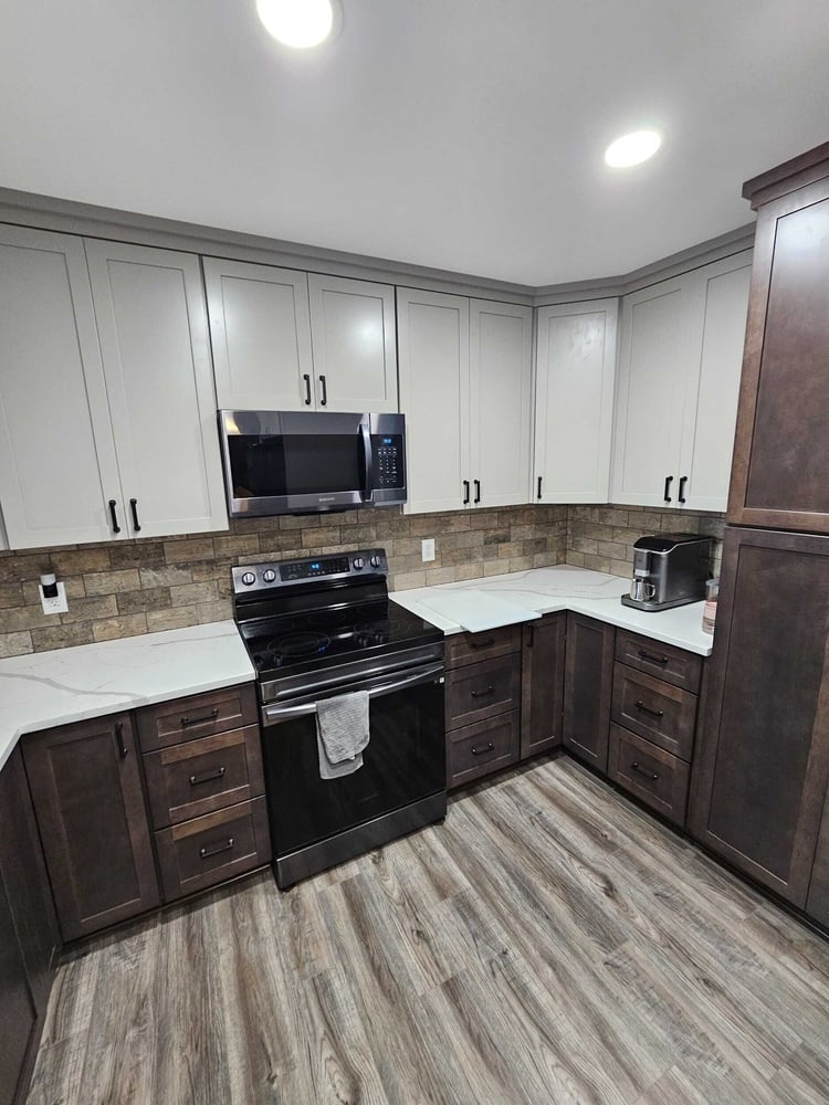 kitchen remodel with large island and quartz countertops by Swank Builders Inc in Grand Blanc, MI